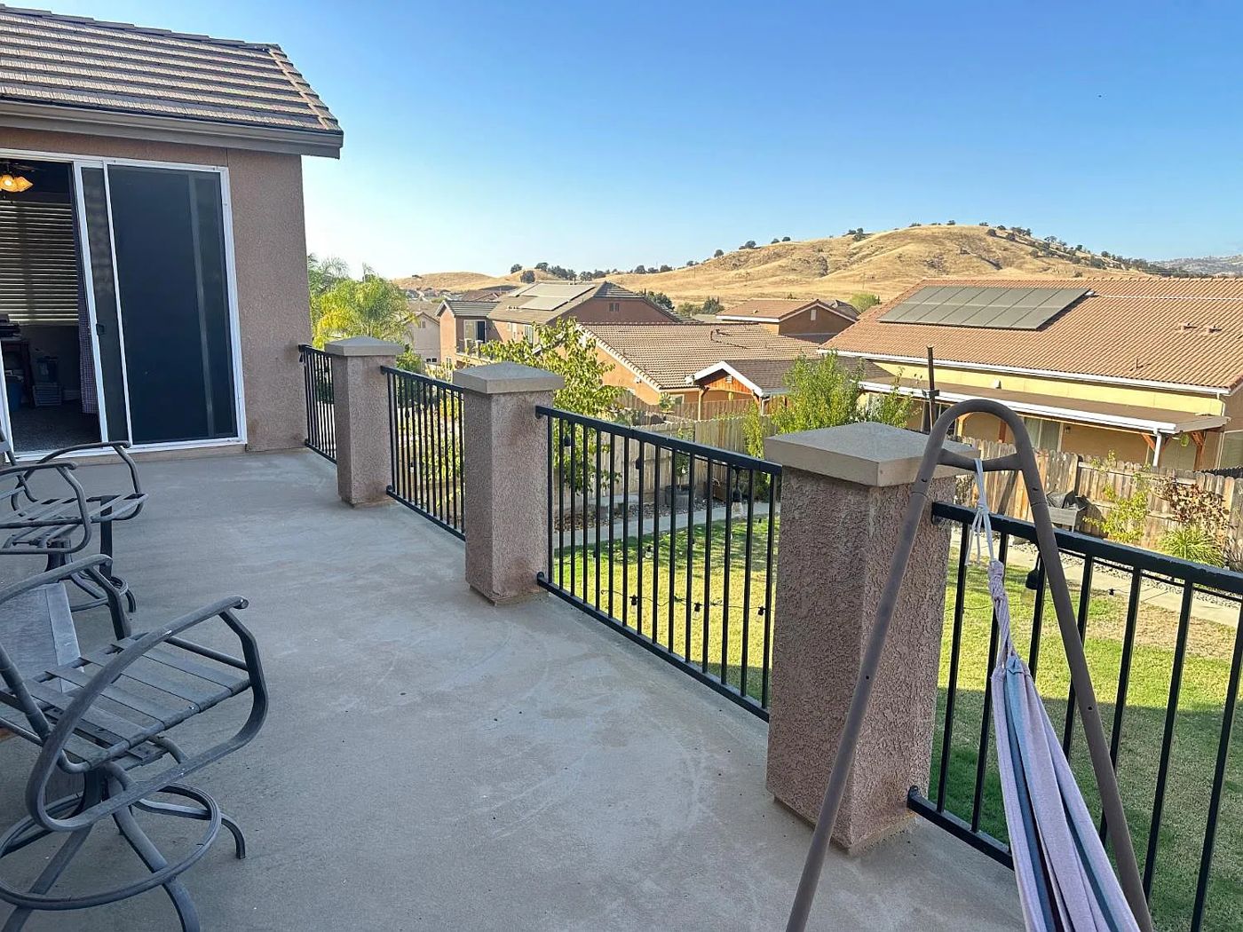 Primary balcony overlooking the backyard and golden foothills