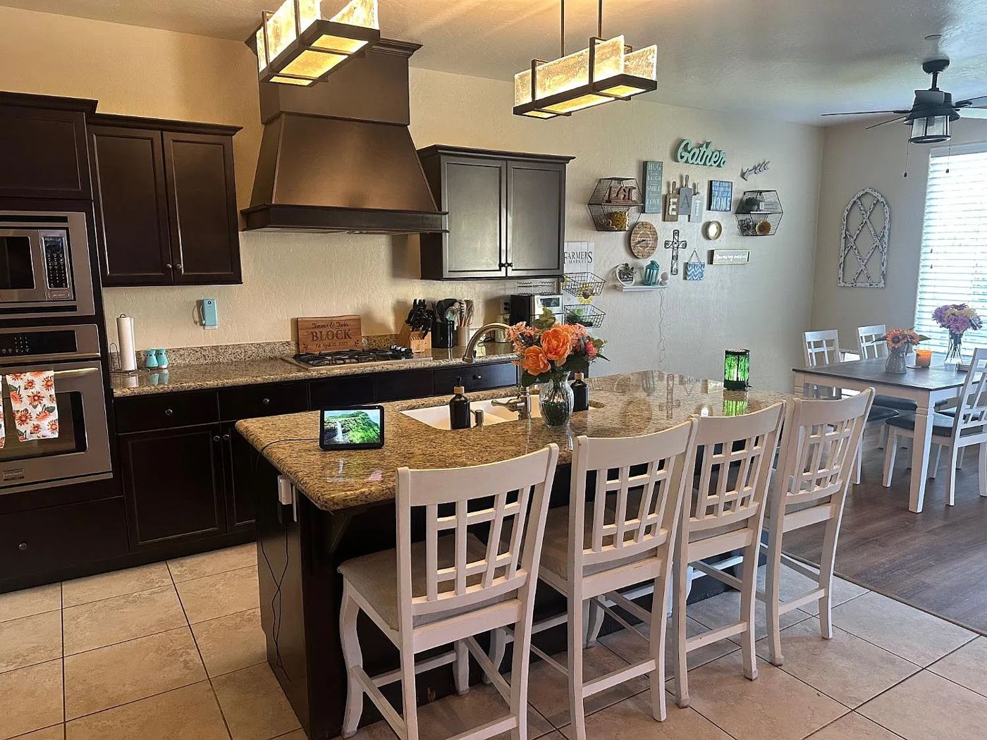 Kitchen island with seating for four opening to the dining area