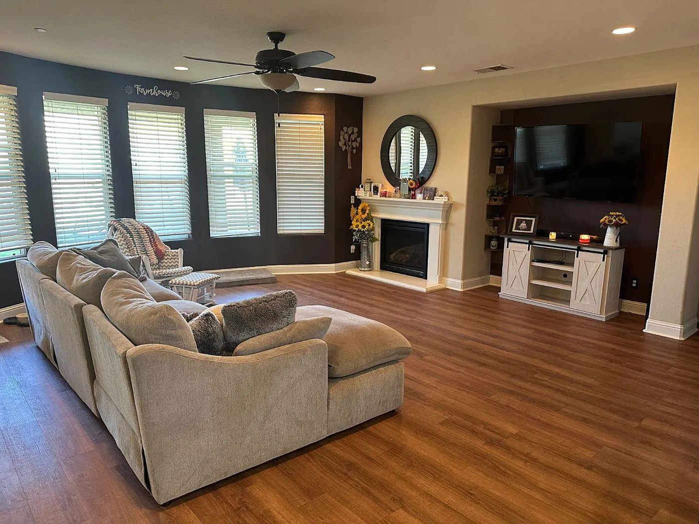 Family room with fireplace, wall of windows and wood-look flooring