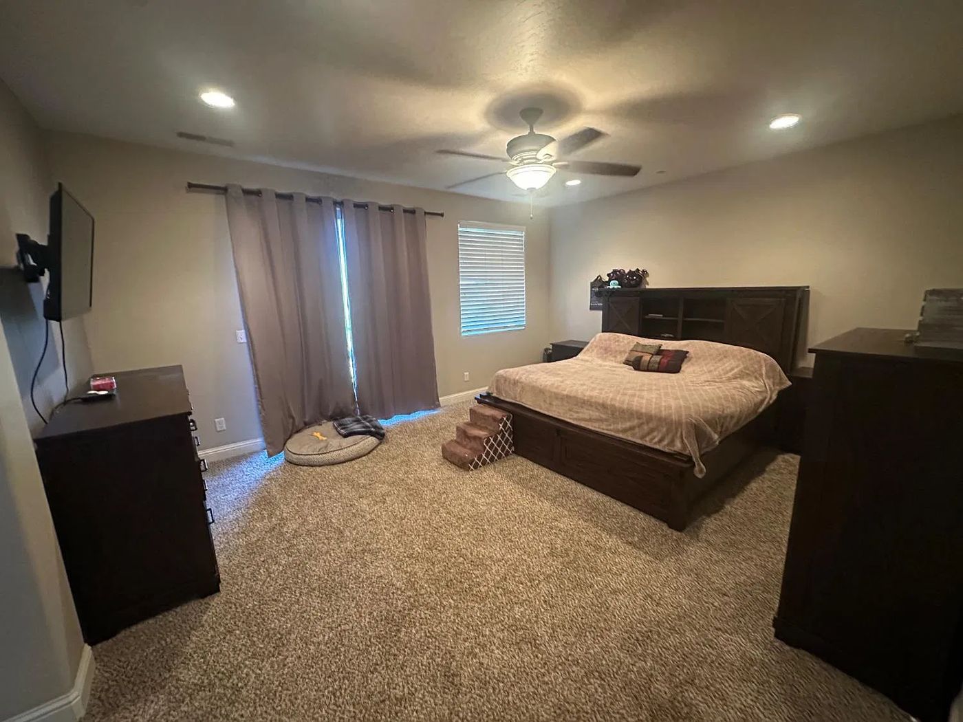 Spacious primary bedroom with balcony door